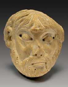 Cap d'home amb barba procedent de la portada del monestir. Marbre. Mestre de Cabestany, segon ter&ccedil; del segle XII. Fitzwilliam Museum, Cambridge